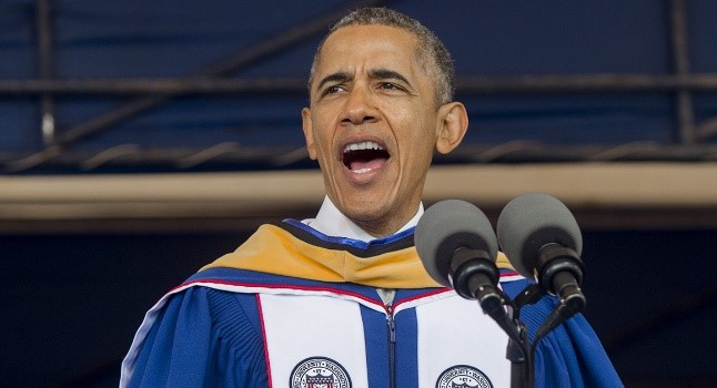 President Obama standing in front of microphones as a guest speaker at HU Graduation