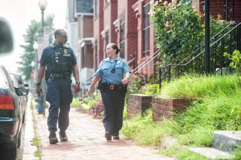 Two DPS officers walking and talking down a quiet street