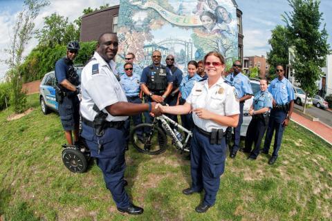 Police officers locking hands posing for a photo