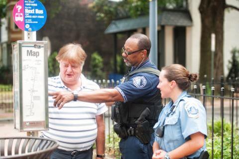 Image of DPS officer providing directions to two people on campus