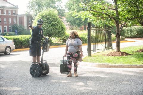 Police officer directing Howard University student on which direction to go