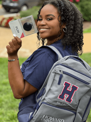 Student holding POM device